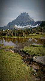 Scenic view of lake and mountains against sky