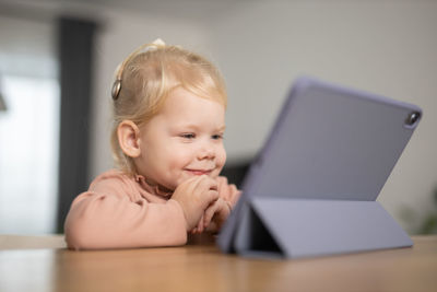 Portrait of cute boy using laptop at home