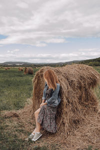 Rear view of woman on field against sky