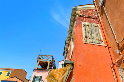 Low angle view of old building against clear blue sky