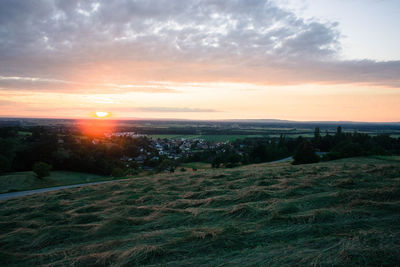 Scenic view of field against sky during sunset
