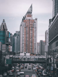 High angle view of traffic on road by buildings against sky