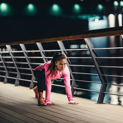 Portrait of girl standing on pink railing