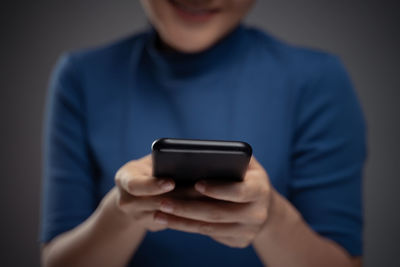 Midsection of man using mobile phone