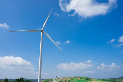 Low angle view of windmill against blue sky