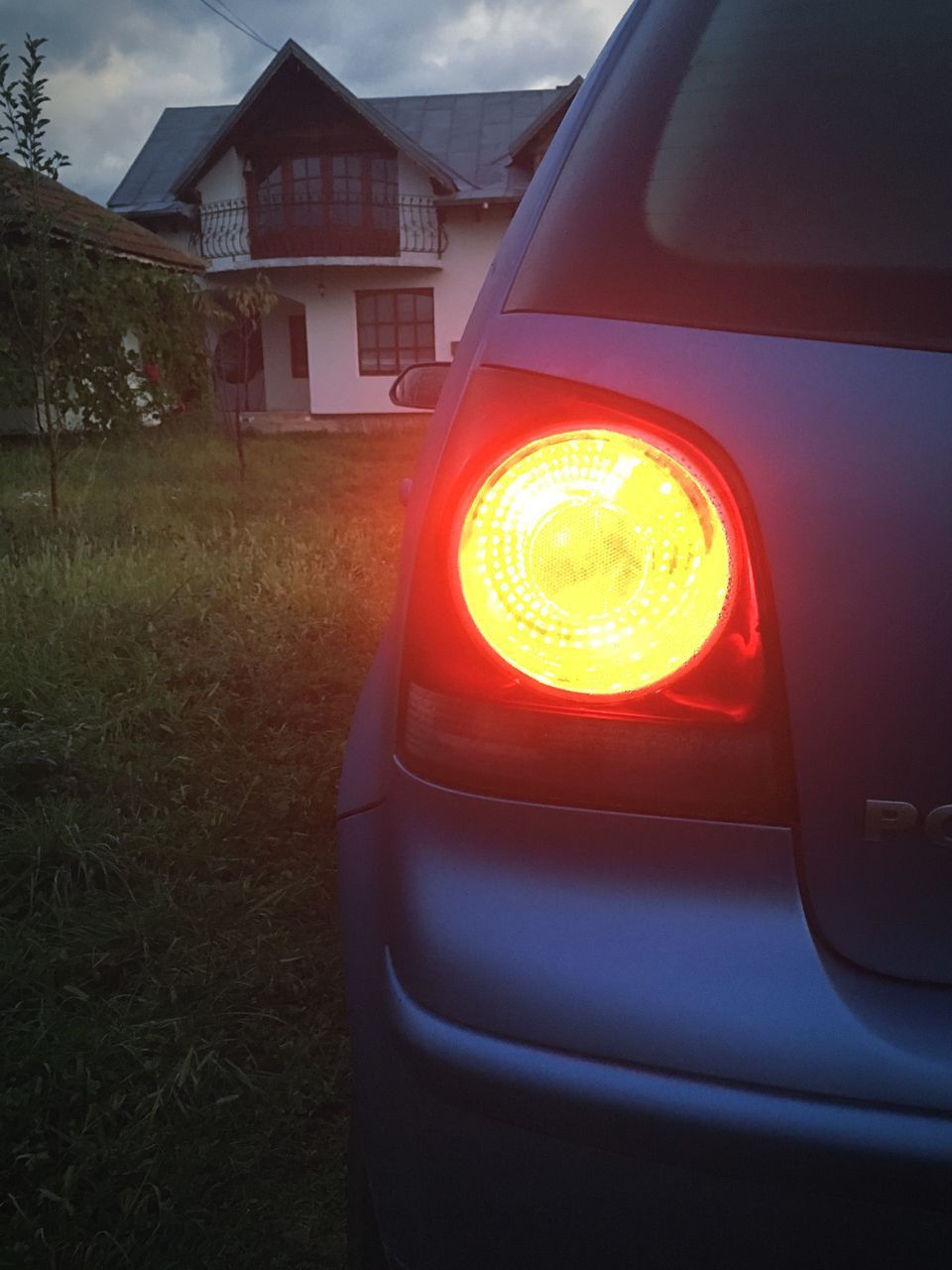 CLOSE-UP OF ILLUMINATED CAR AGAINST BUILDING