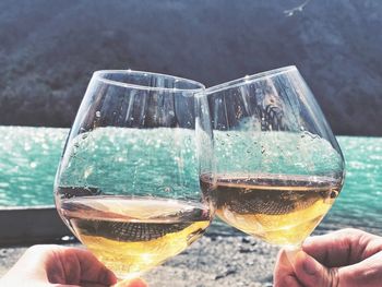 Close-up of hand holding beer glass