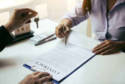 Midsection of business colleagues working at table