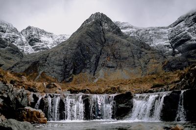 Scenic view of waterfall against sky