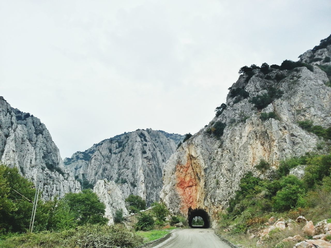 mountain, the way forward, rock formation, rock - object, sky, road, tranquility, transportation, tranquil scene, scenics, nature, rocky mountains, beauty in nature, non-urban scene, landscape, cliff, mountain range, geology, day, rock