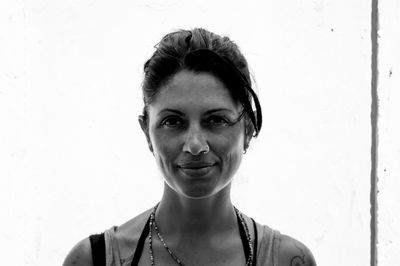 Portrait of young woman against wall