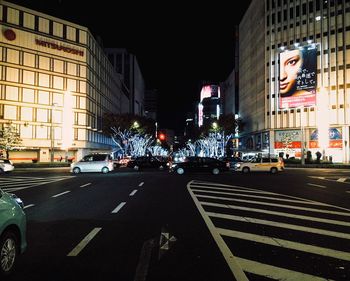 Illuminated city street at night