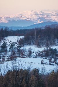 Scenic view of snow covered mountains against sky