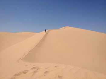 Scenic view of desert against clear sky