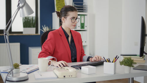 Portrait of young businesswoman working in office