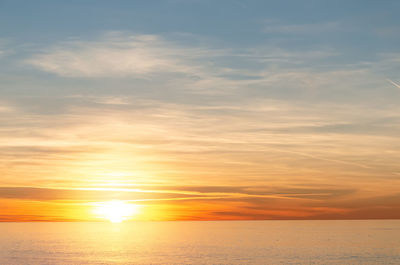 Scenic view of sea against romantic sky at sunset