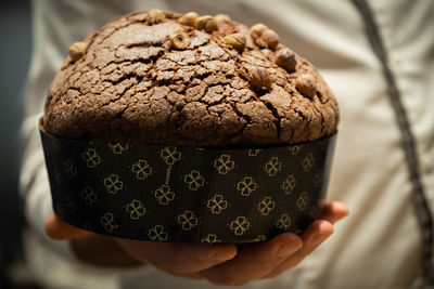 Close-up of hand holding cake