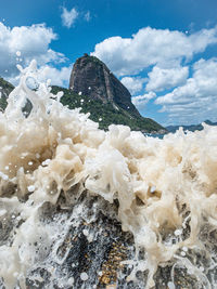 Scenic view of rocks in sea against sky