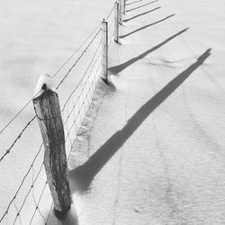 High angle view of shadow on wooden fence