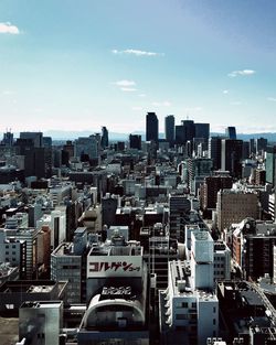 View of cityscape against cloudy sky