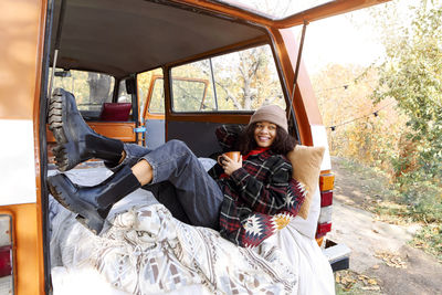 Rear view of woman sitting in car