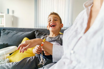 Boy smiling while relaxing on bed at home