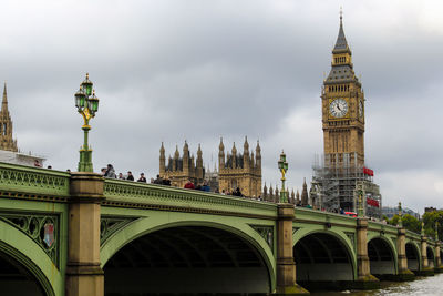 Low angle view of clock tower against cloudy sky