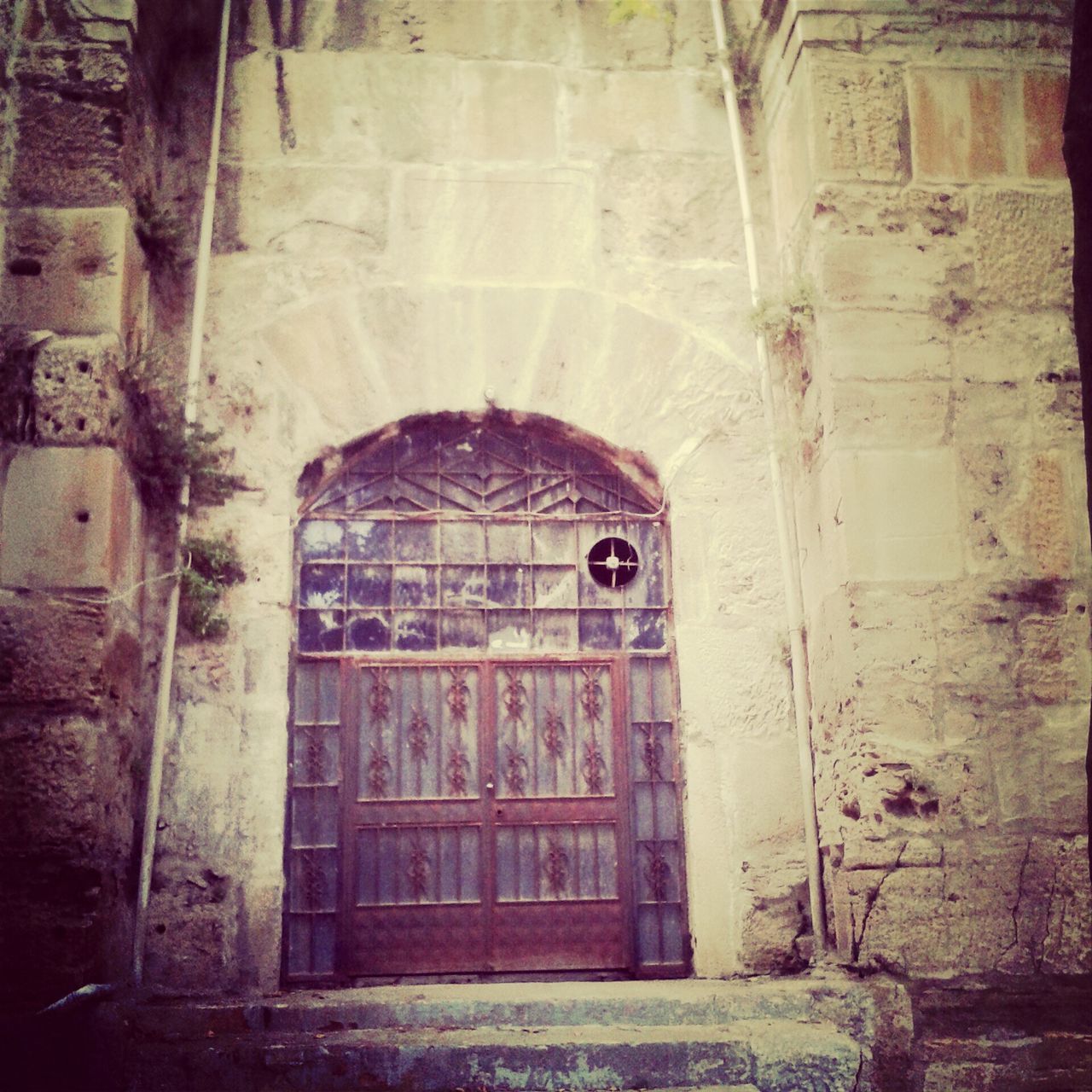 architecture, built structure, building exterior, window, arch, old, building, door, entrance, history, brick wall, wall - building feature, abandoned, closed, indoors, weathered, day, no people, low angle view, historic