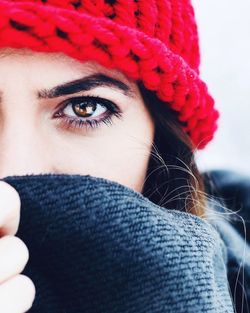 Close-up portrait of woman wearing red knit hat