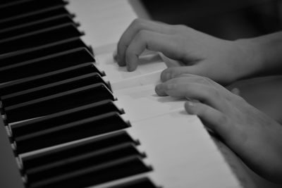 Close-up of hands playing piano