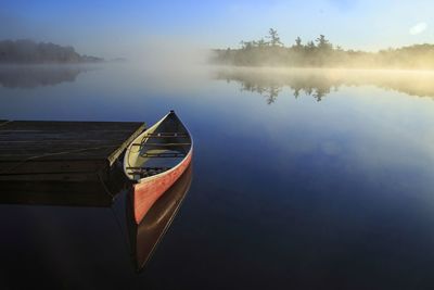 Red canoe on a blue calm lake