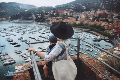 High angle view of woman looking at river in city