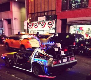 Cars on city street at night