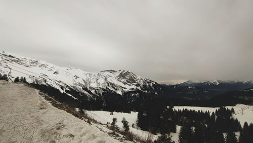 Scenic view of snowcapped mountains against sky