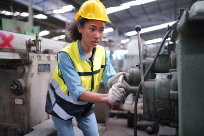 Side view of man working in factory