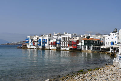 Boats in sea against clear sky