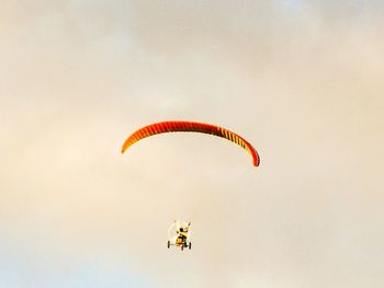 Person paragliding against sky