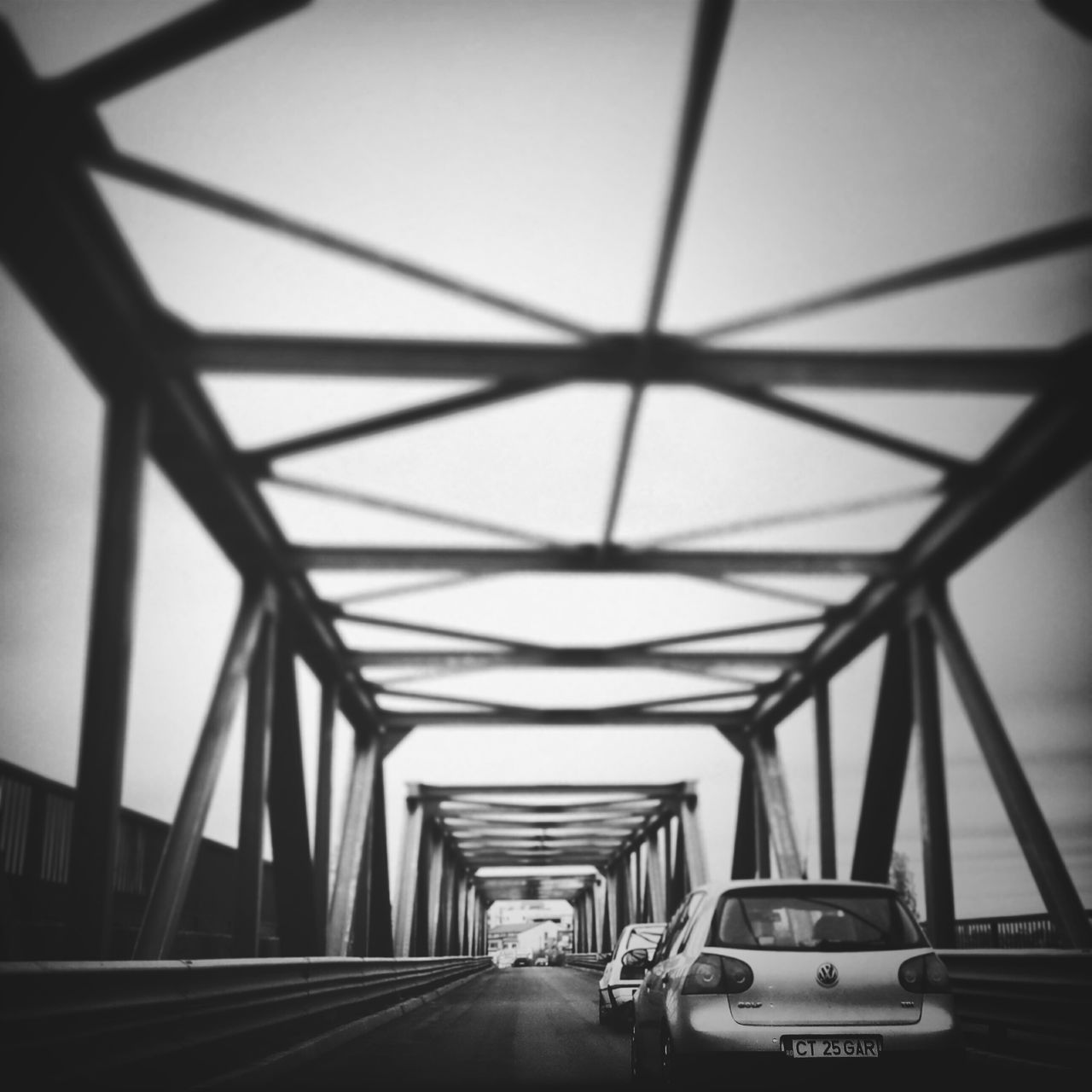 transportation, mode of transport, the way forward, land vehicle, connection, car, diminishing perspective, bridge - man made structure, engineering, road, vanishing point, travel, built structure, architecture, bridge, on the move, sky, clear sky, public transportation, road marking