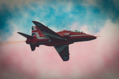 Low angle view of airplane flying against sky