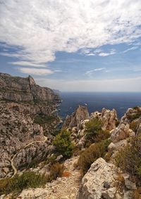 Rock formations by sea against sky