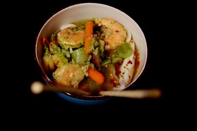 Close-up of food in bowl against black background