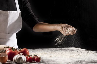 Midsection of chef preparing food