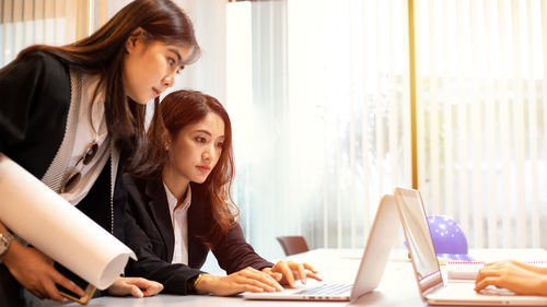 Businesswoman using laptop at home