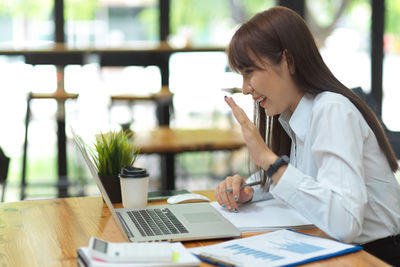 Businesswoman video conference meeting with co-workers