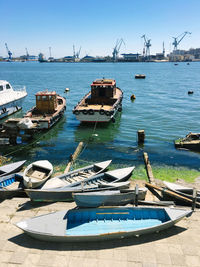 Boats moored at harbor in city
