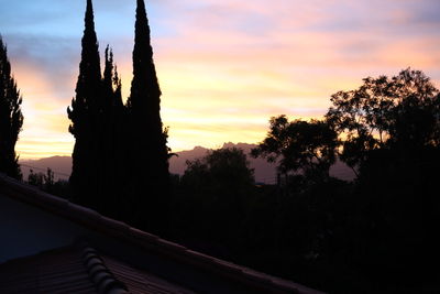 Silhouette of trees against sky at sunset