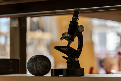 Close-up of microscope on table