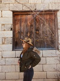 Woman standing against wall