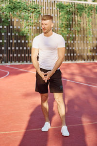 Full length of man exercising on court