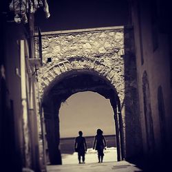 Low angle view of woman standing on railing